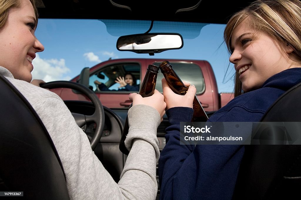 Girls drinking and driving accident Two teen girls drinking, driving and not paying attention to the truck in front of them that they are about to hit. Car Accident Stock Photo