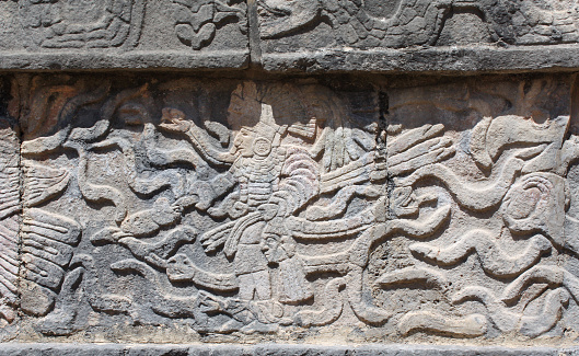 Bas-relief carving with indian warrior and serpents, pre-Columbian Maya civilization, Chichen Itza, Yucatan, Mexico. UNESCO world heritage site