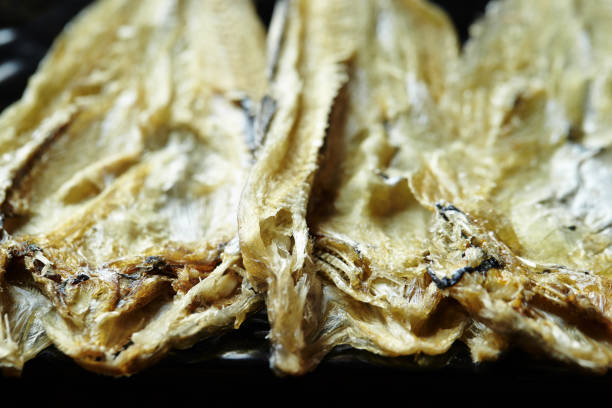 istock Closeup of appetizing dried fish on a black surface 1479141125