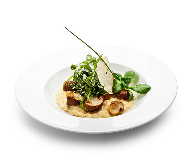 White bowl containing mushroom risotto and basil