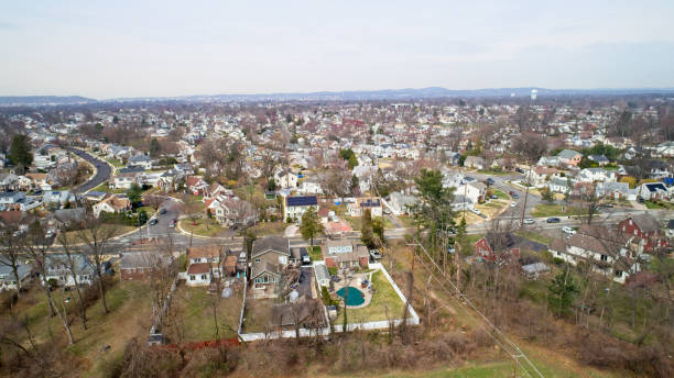 istock Middle Class Neighborhood flyover at treetop level 1479149108
