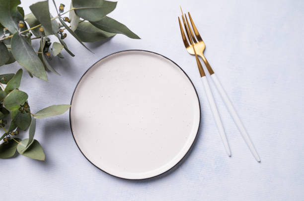 istock Festive table setting for a spring celebration, wedding, birthday or mother's day with eucalyptus branches on a light background. The concept of the restaurant menu. 1479149151