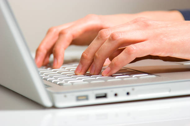 istock fingers and hands on laptop 147914943