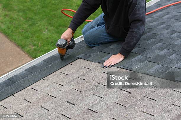 Worker Adding Shingles To Roof Stock Photo - Download Image Now - Repairing, Rooftop, Construction Industry