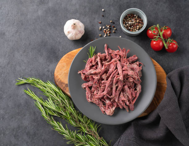 istock Traditional bbq torn  beef or lamb meat with spice, fresh tomatoes and herbs on a dark background. 1479150824