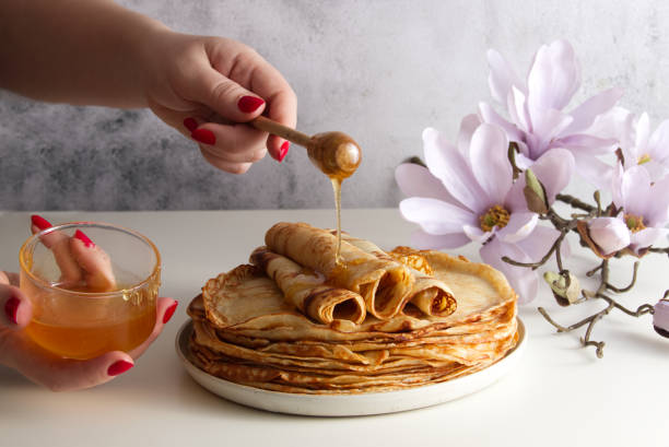 istock Stack of fresh crepes with honey and raspberries on the table copy space 1479153412