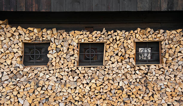 Wooden Log Farm House With Firewood stock photo