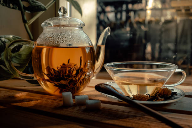 istock a teapot and cup with tea on a wooden table. 1479155465