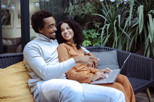 istock Happy couple using laptop in the back yard and enjoying 1479159018