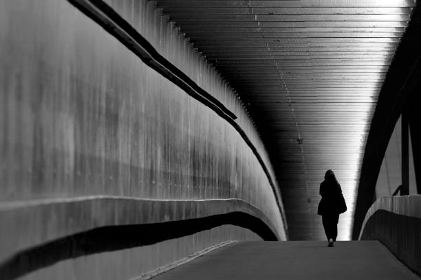 istock Pedestrian under bridge at night in black and white 1479159611