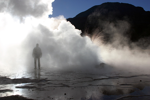 Man at El Tatio geysers, Chile at sunrise