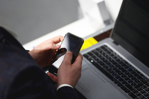 Close-up of a business man hands using smart phone