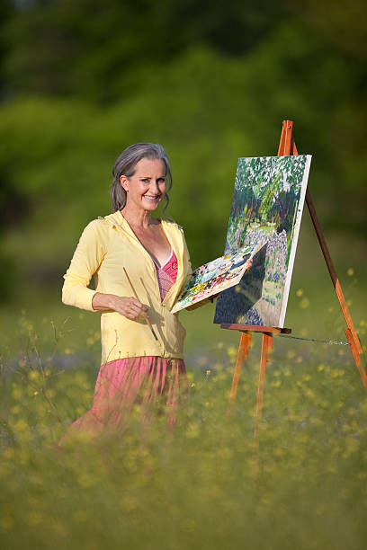 istock Senior Lady Outdoors Painting On Canvas 147916371