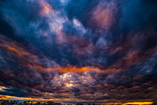 Dramatic colorful clouds after storm at sunset