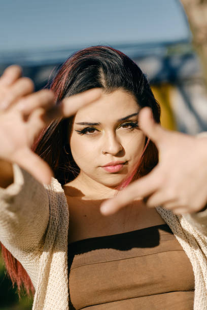 istock Young Latina woman frames her face with her hands 1479166645