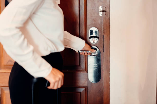 istock A young woman is opening a door using a card key 1479168451