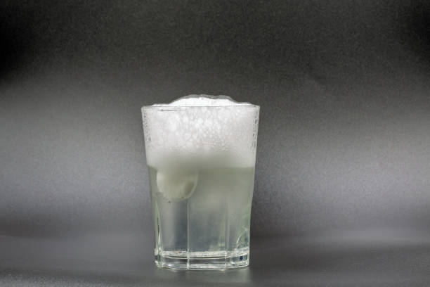 istock Dissolving instant effervescent tablets in a glass of water closeup 1479169032
