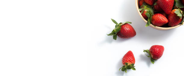 istock Fresh fruit strawberries in paper packaging on a white background. Top view, flat lay. Banner 1479169278