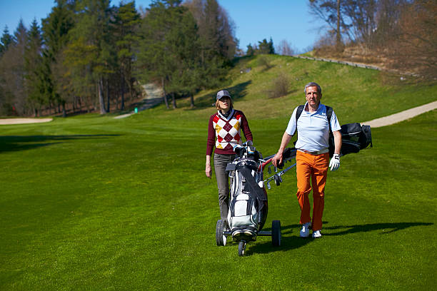istock Man and woman walking on a golf course 147917092