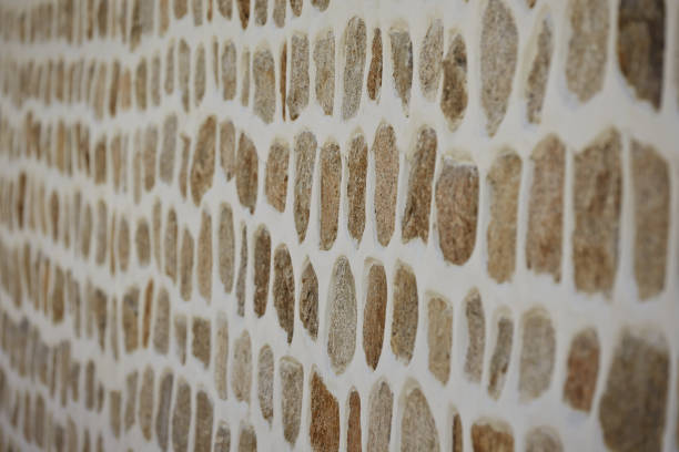 istock Blurry shot of a natural brown stone wall background 1479172904