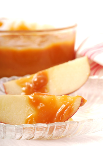 Freshly sliced apples with a caramel dipping sauce drizzled on them
