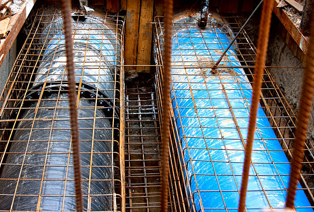 Two sewer pipes under reinforcing steel stock photo