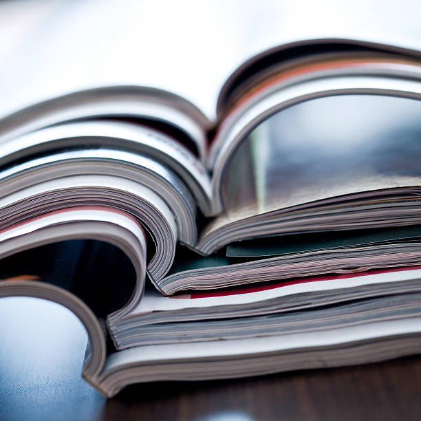 istock Stack of open colorful magazines - close-up 147918971