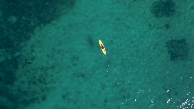 above view of yellow kayak on azure transparent water