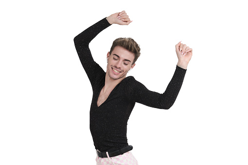 Young caucasian man dancing with earphones, isolated on white background.