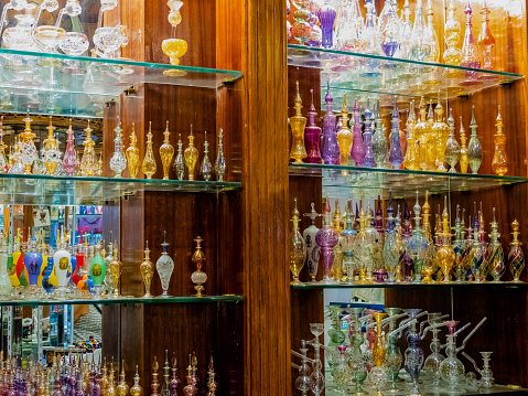 Colorful and delicate Egyptian perfume bottles on a shelf.