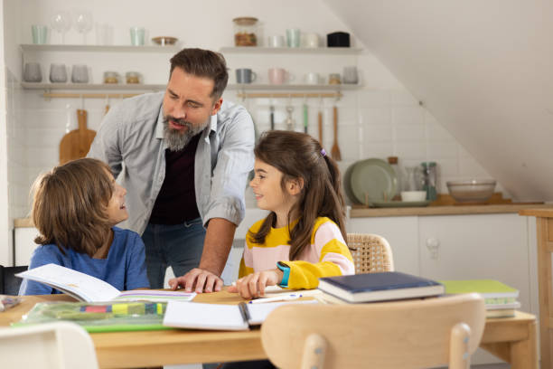 istock Brother and sister doing homework with their caregiver 1479200103