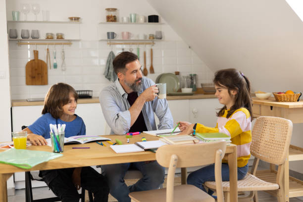 istock Brother and sister doing homework with their caregiver 1479200113