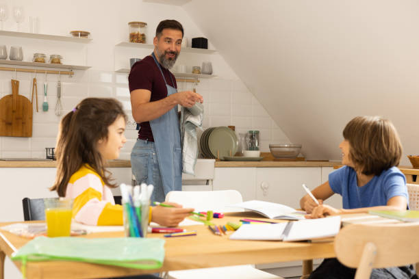 istock Father doing housework and helping his kids with homework 1479200152