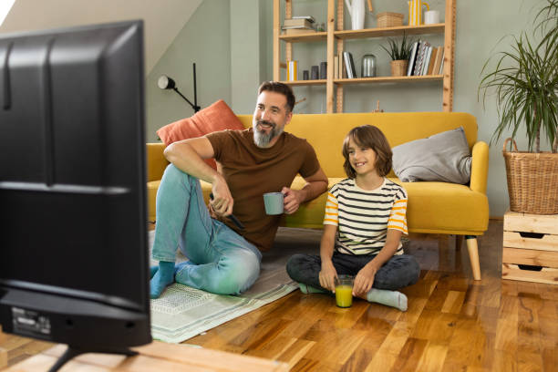 istock Boy watching TV with his dad at home 1479200190