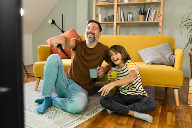 Father and son enjoying at home and watching TV
