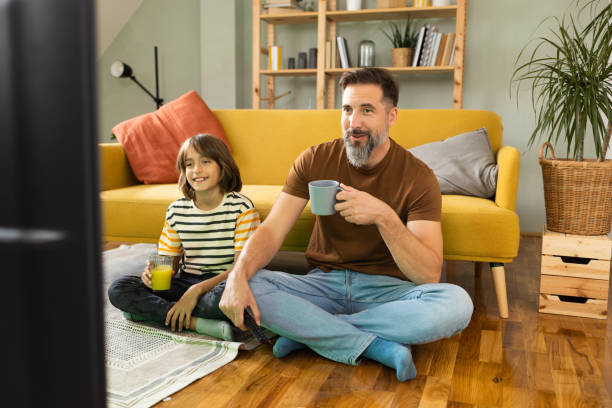 istock Boy watching TV with his dad at home 1479200204