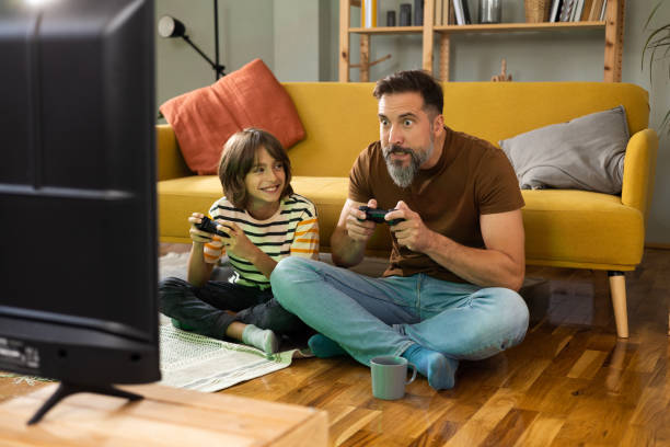 istock Father and son gaming at home 1479200206