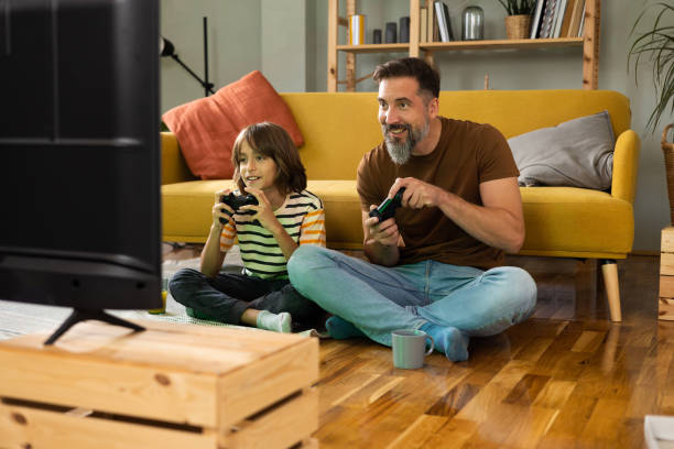 istock Man and his little boy gaming and having fun 1479200212