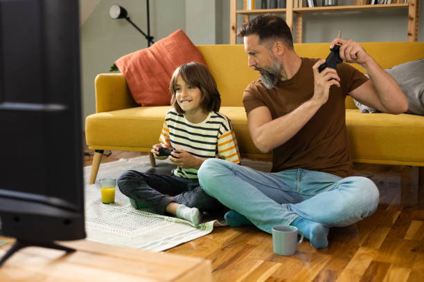 istock Man and his son competing in gaming at home 1479200216