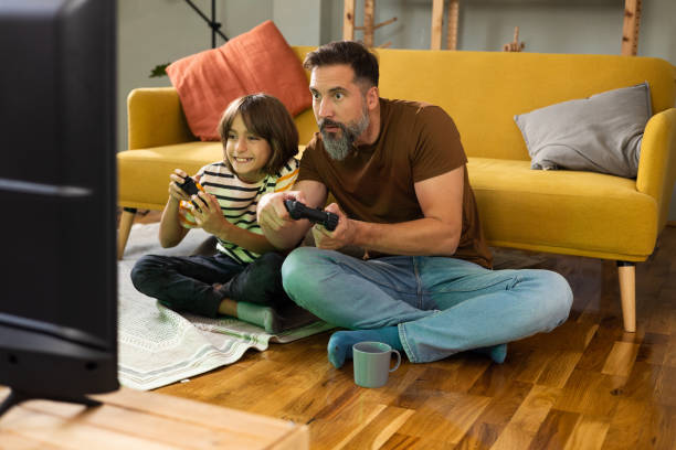 istock Boy and his dad gaming and having fun at home 1479200220