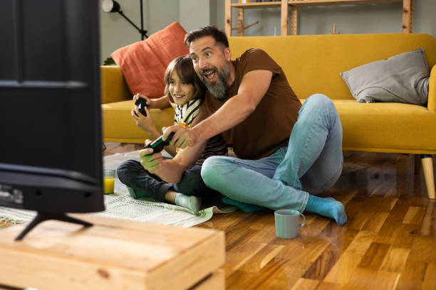 istock Gather and son playing video games and enjoying at home 1479200221