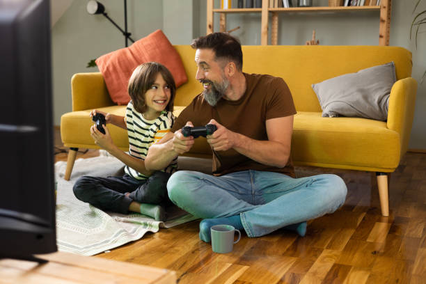 istock Man and his little boy gaming and having fun 1479200223
