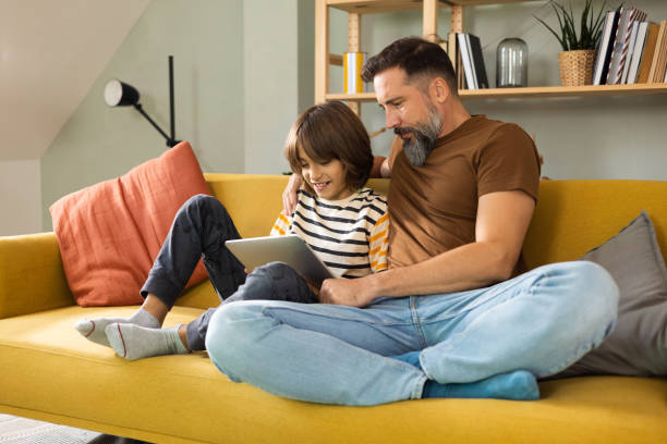 istock Father and son enjoying together and using a digital tablet 1479200233