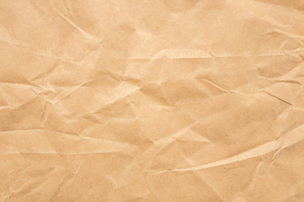 istock Abstract brown crumpled creased recycle paper texture background 1479200425