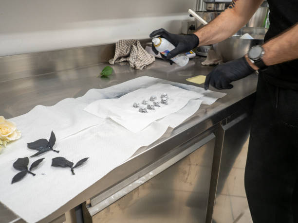 istock pastry chef preparing topping elements for birthday cake, roses, skulls, meringue swirls and leaf 1479200837