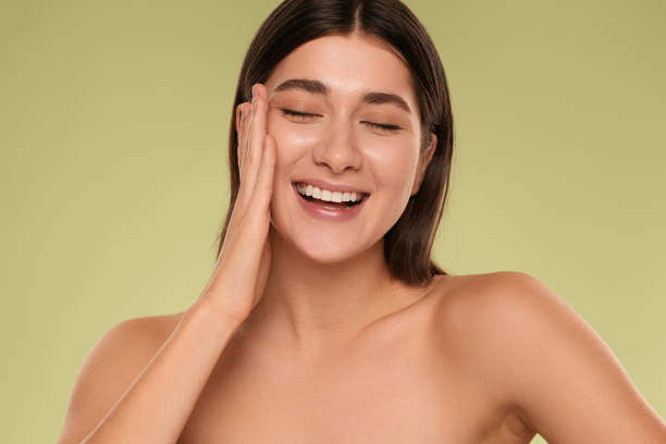istock Happy young woman touching clean face 1479201522
