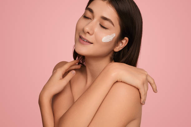 istock Sensual model with cream smear on cheek 1479201564