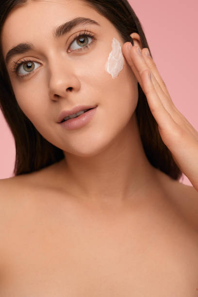 istock Woman with cosmetic cream on face 1479201566