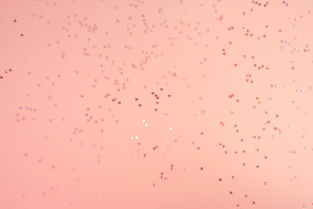 istock Pink pastel background with small hearts confetti. Flatlay, top view, copy space 1479201644