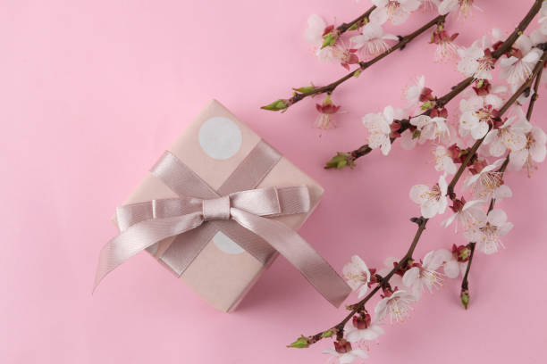 istock Flowering branch. Spring flowers and gift box on a bright pink background. top view. 1479202016